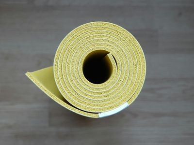 Close-up of a neatly rolled yoga mat.